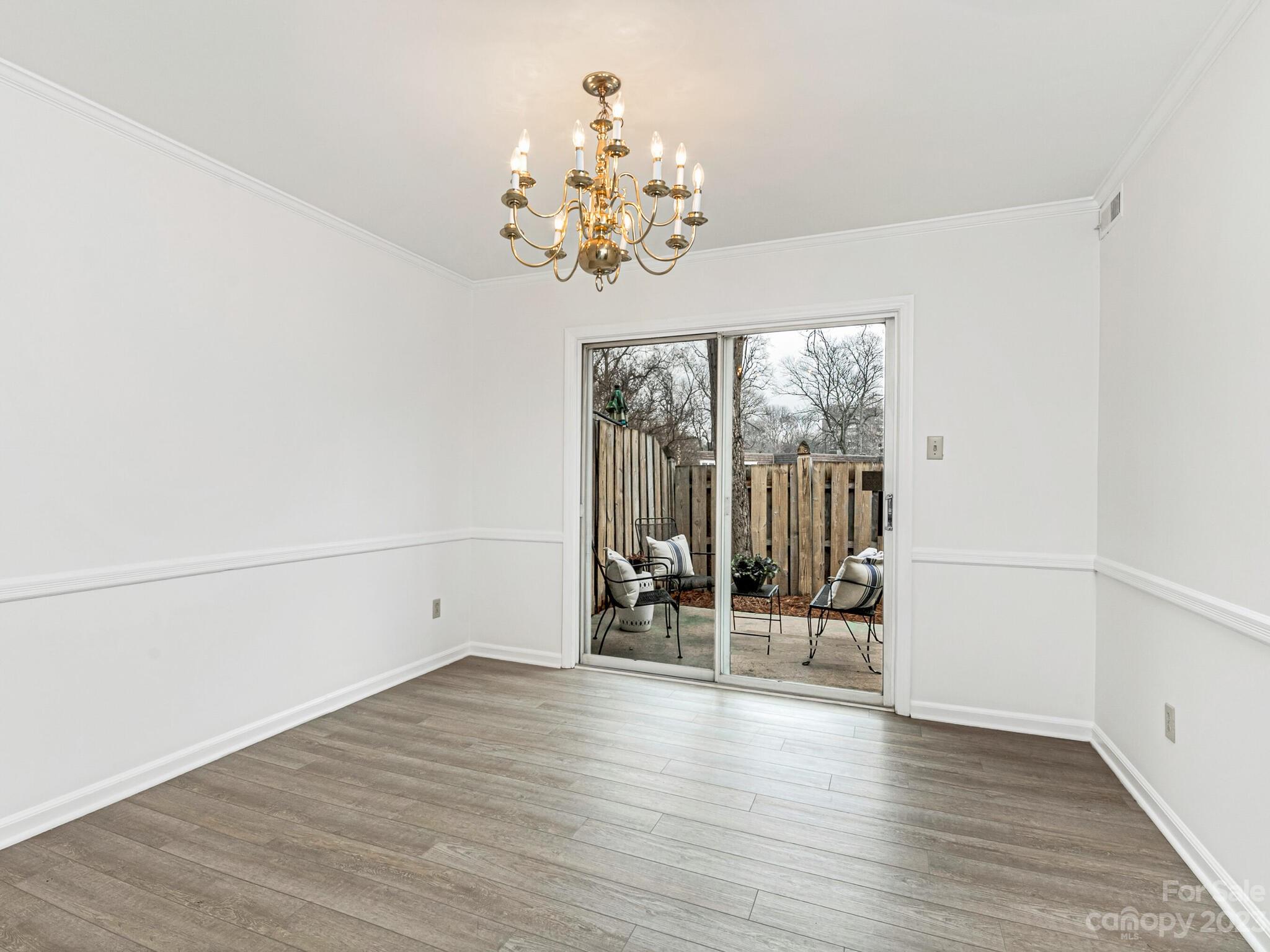 2227 Rexford Road, Unit B Charlotte, NC 28211 - Photo 6 of 23 wooden floor in an empty room with a window