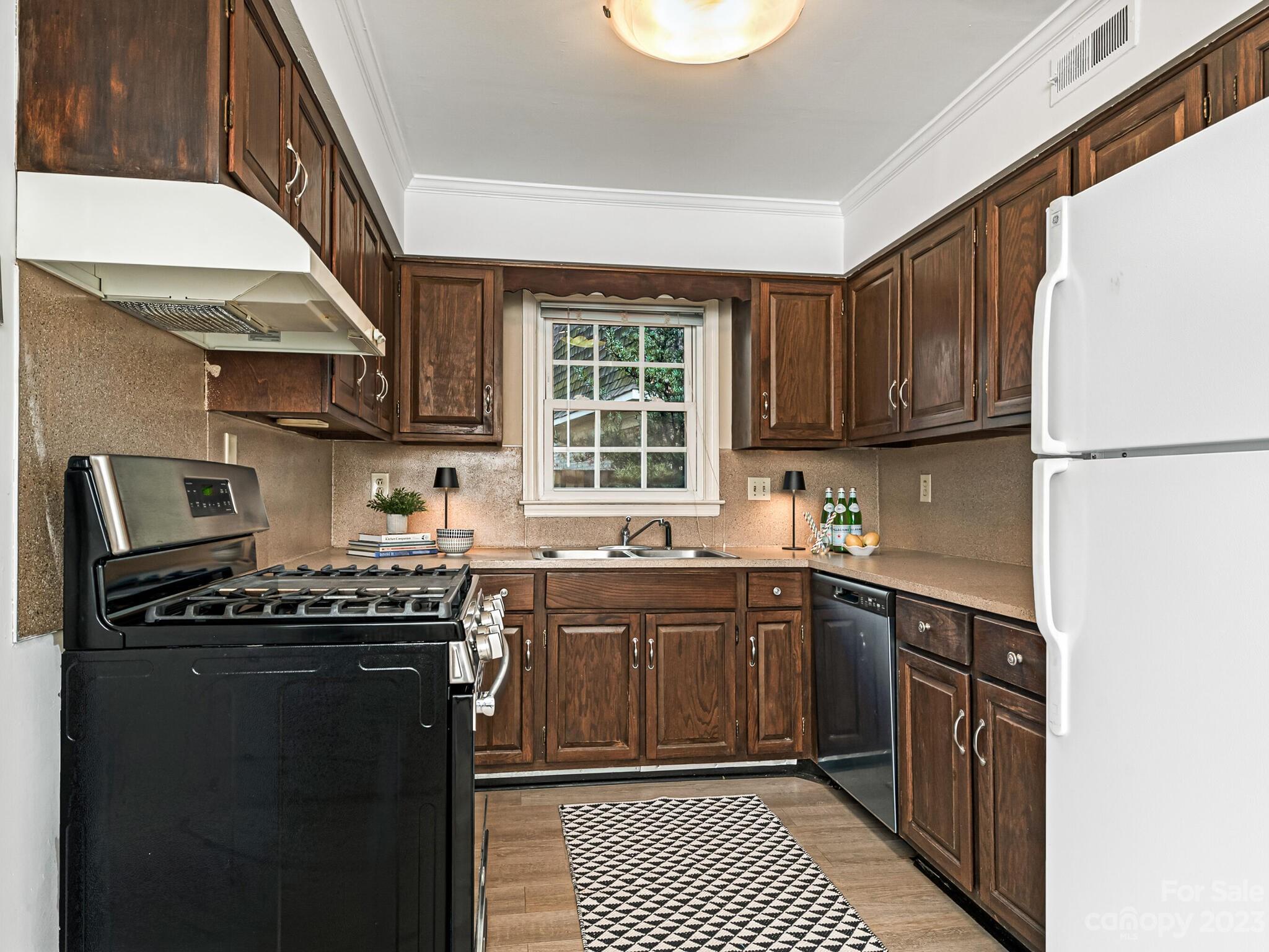 2227 Rexford Road, Unit B Charlotte, NC 28211 - Photo 8 of 23 a kitchen with stainless steel appliances granite countertop a stove a sink dishwasher and a refrigerator