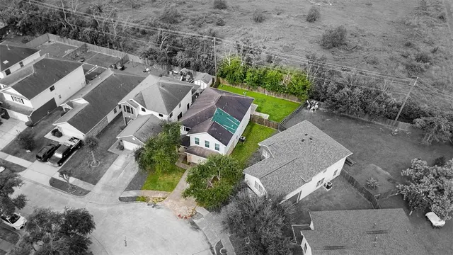 an aerial view of a house with a yard