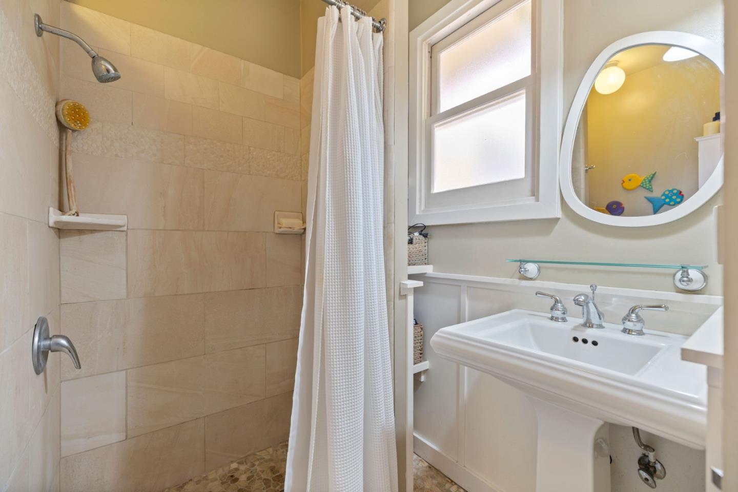 106 Lawn Way Capitola, CA 95010 - Photo 13 of 21 a bathroom with a sink a window and a mirror