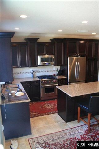 9280 Lost Valley Road Reno, NV 89521 - Photo 2 of 13 a kitchen with stainless steel appliances granite countertop a stove a sink and a refrigerator