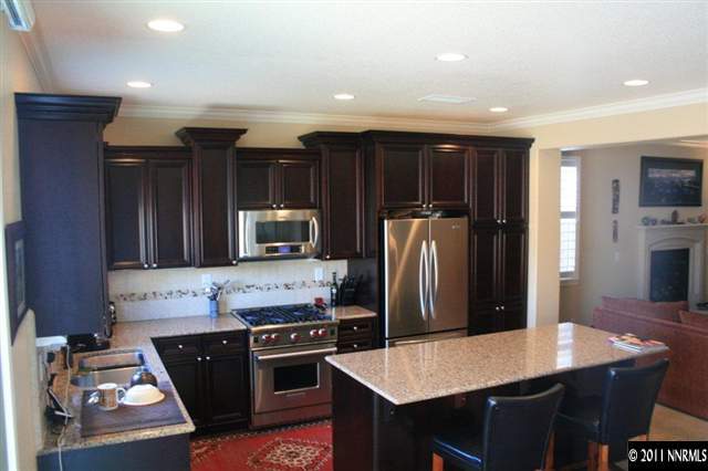 9280 Lost Valley Road Reno, NV 89521 - Photo 3 of 13 a kitchen with stainless steel appliances granite countertop a refrigerator stove top oven a sink and dishwasher