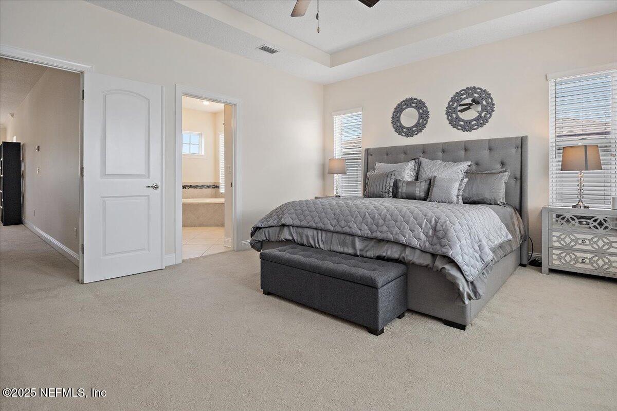 166 Portside Avenue Ponte Vedra, FL 32081 - Photo 20 of 46 a spacious bedroom with a bed and cabinets