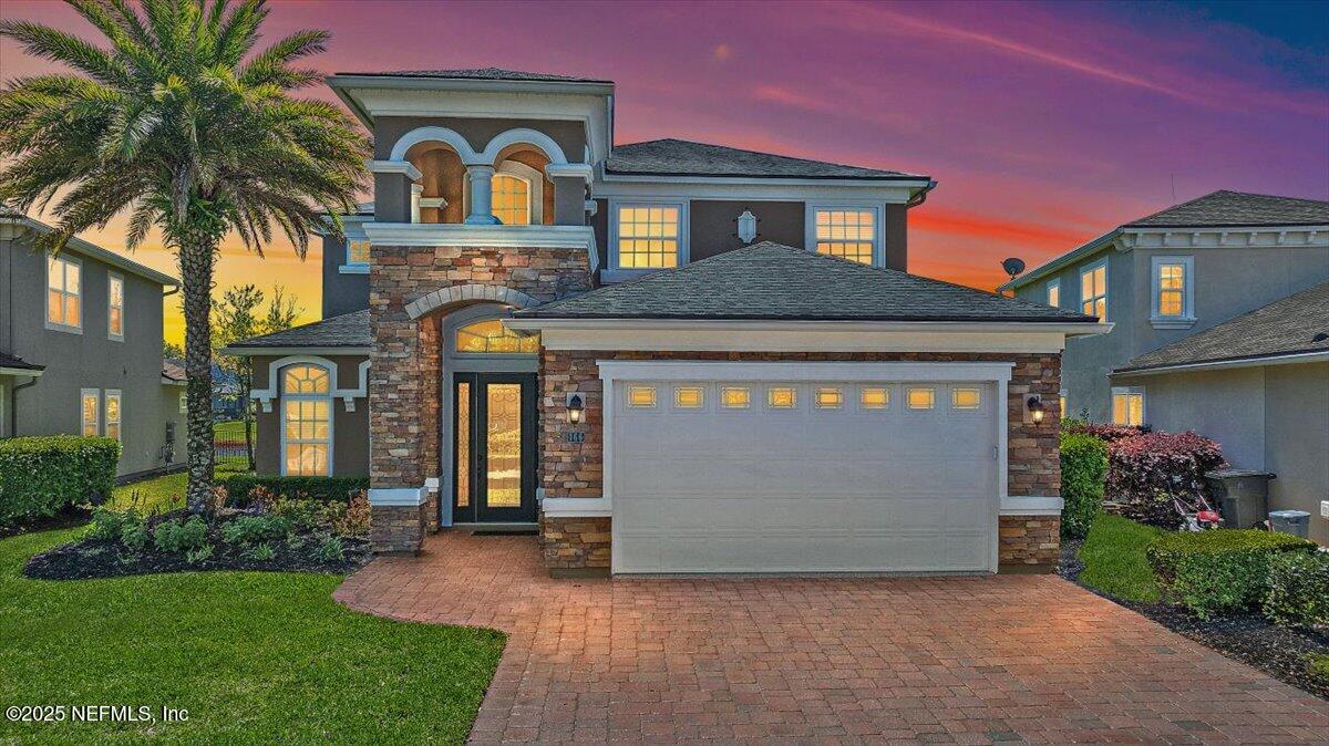 166 Portside Avenue Ponte Vedra, FL 32081 - Photo 2 of 46 a front view of a house with a garden and plants