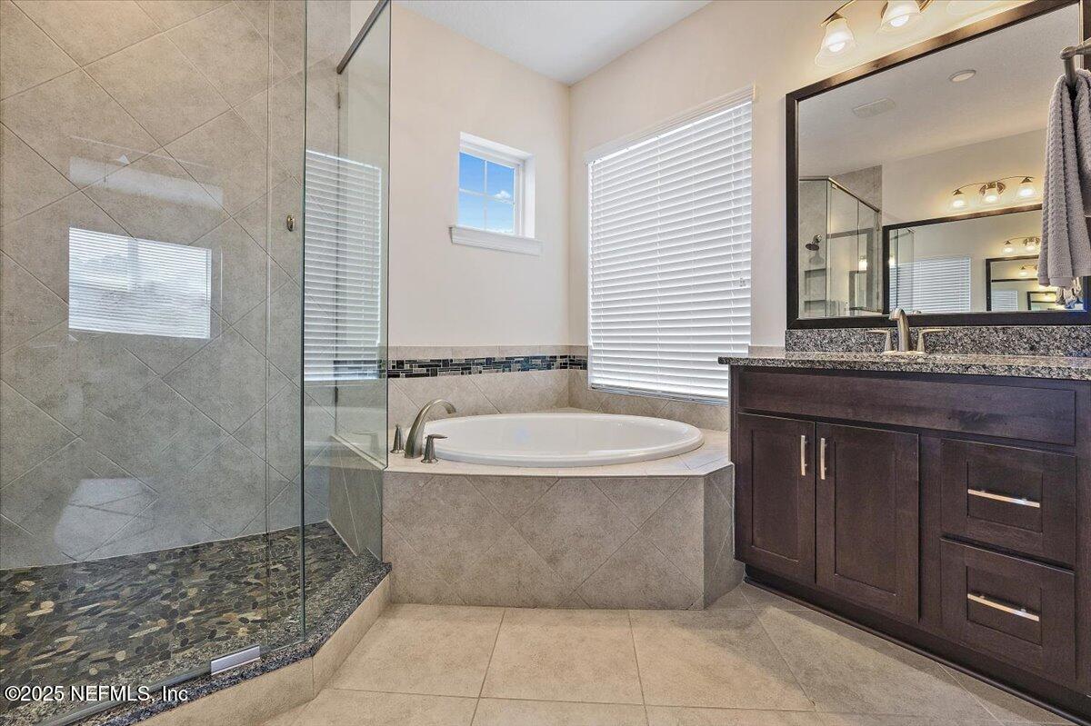 166 Portside Avenue Ponte Vedra, FL 32081 - Photo 23 of 46 a bathroom with a bathtub sink and mirror