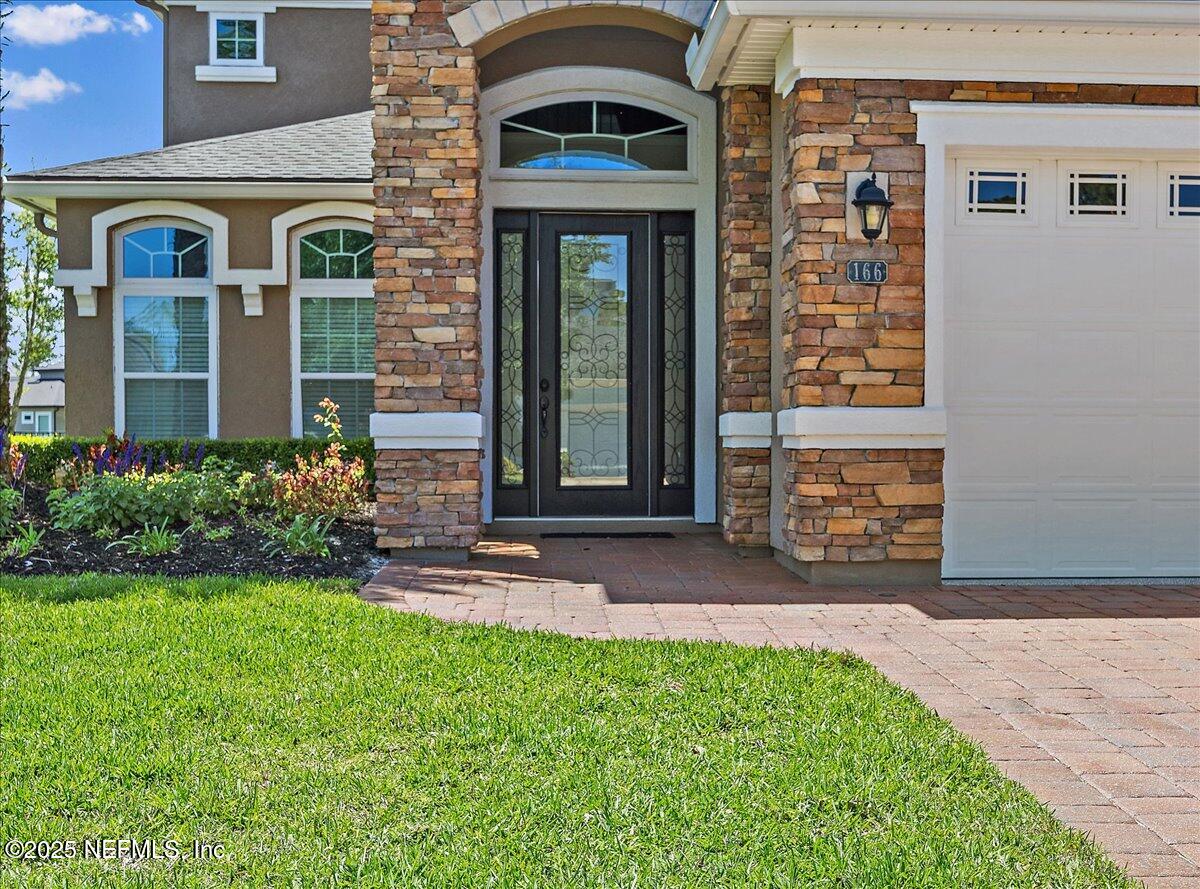 166 Portside Avenue Ponte Vedra, FL 32081 - Photo 4 of 46 a front view of a house with garden