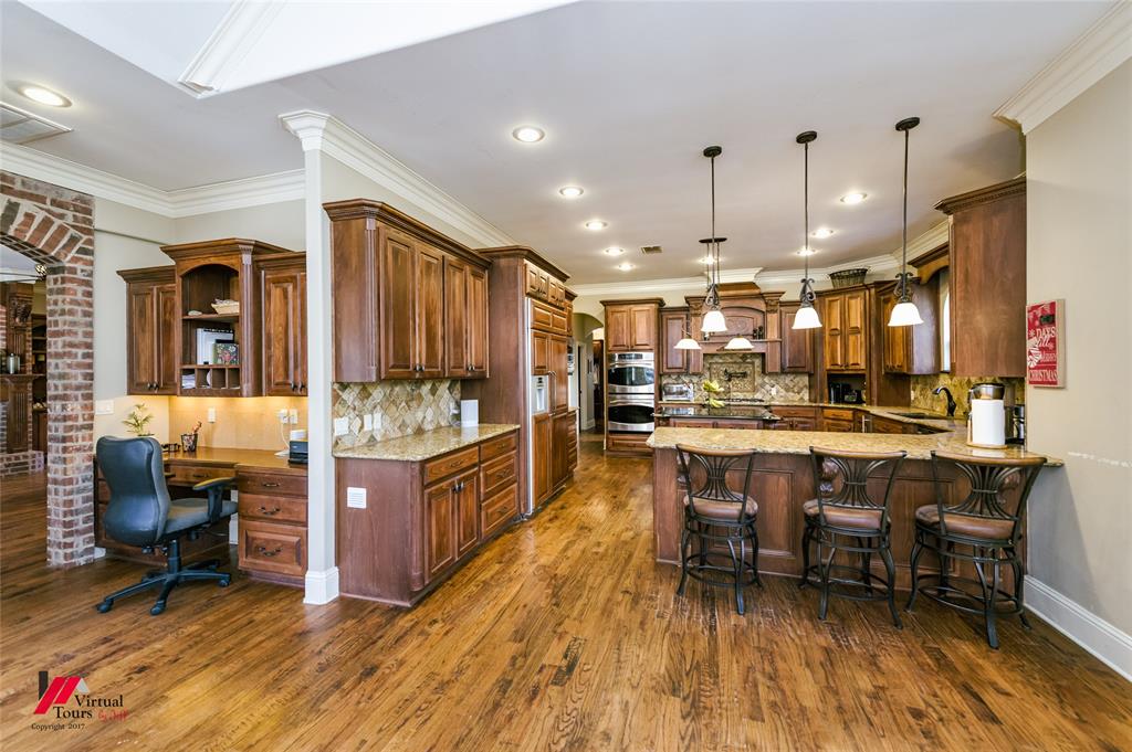 5180 Linton Cutoff Road Benton, LA 71006 - Photo 14 of 40 a kitchen with stainless steel appliances kitchen island granite countertop a stove a sink a refrigerator and a dining table