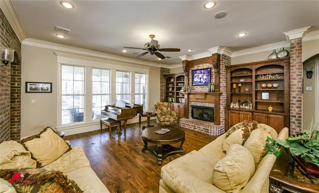 a living room with fireplace furniture and a flat screen tv