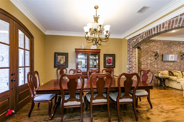 a view of a dining room with furniture wooden floor and chandelier