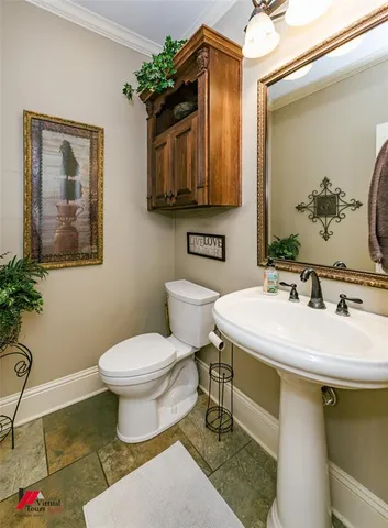 a bathroom with a sink toilet and mirror