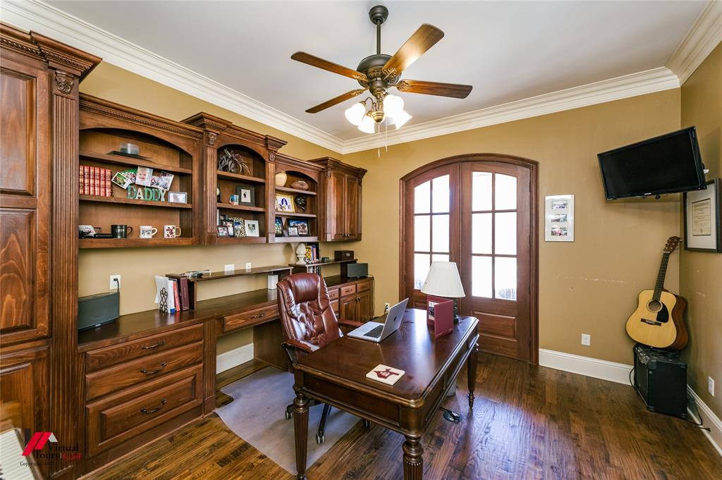 5180 Linton Cutoff Road Benton, LA 71006 - Photo 20 of 40 a living room with furniture a flat screen tv and a floor to ceiling window
