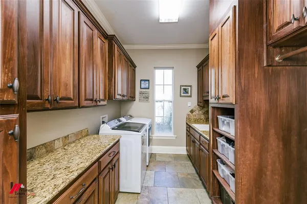 a kitchen with stainless steel appliances granite countertop a refrigerator and a stove