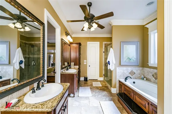 a bathroom with a tub sink and mirror