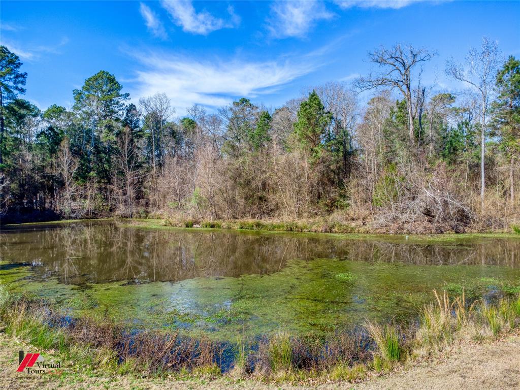 5180 Linton Cutoff Road Benton, LA 71006 - Photo 38 of 40 a view of a lake with a yard