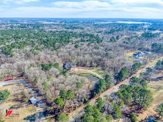 an aerial view of a houses with a yard