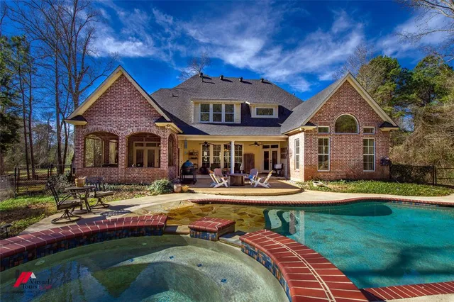 a front view of a house with swimming pool having outdoor seating