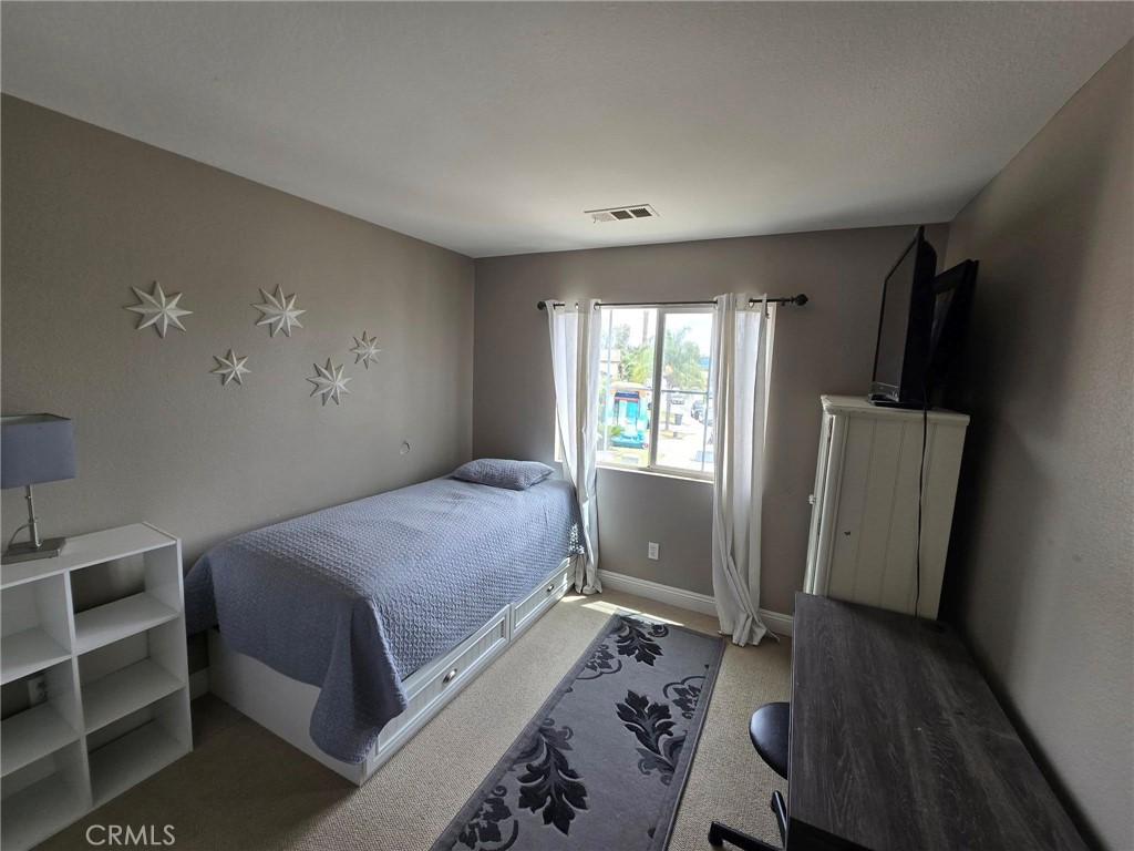 1315 Plaza Way Perris, CA 92570 - Photo 13 of 37 a bedroom with a bed and a window