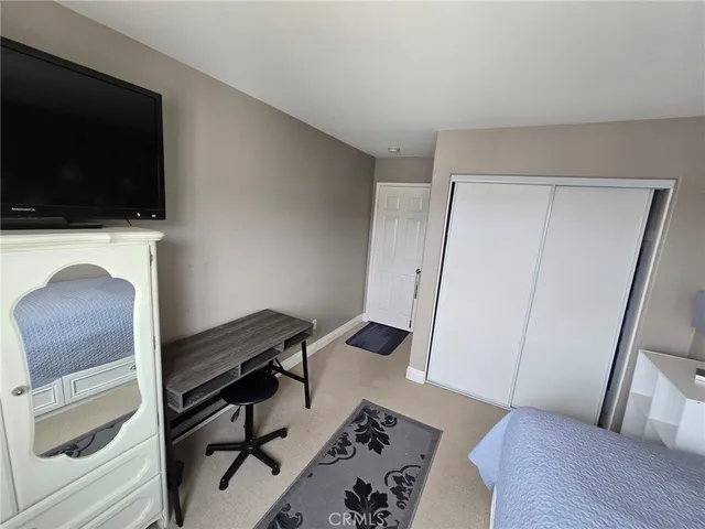 a view of a livingroom with furniture and a flat screen tv