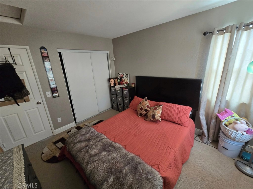 1315 Plaza Way Perris, CA 92570 - Photo 19 of 37 a bedroom with a bed and a flat tv screen on the dresser