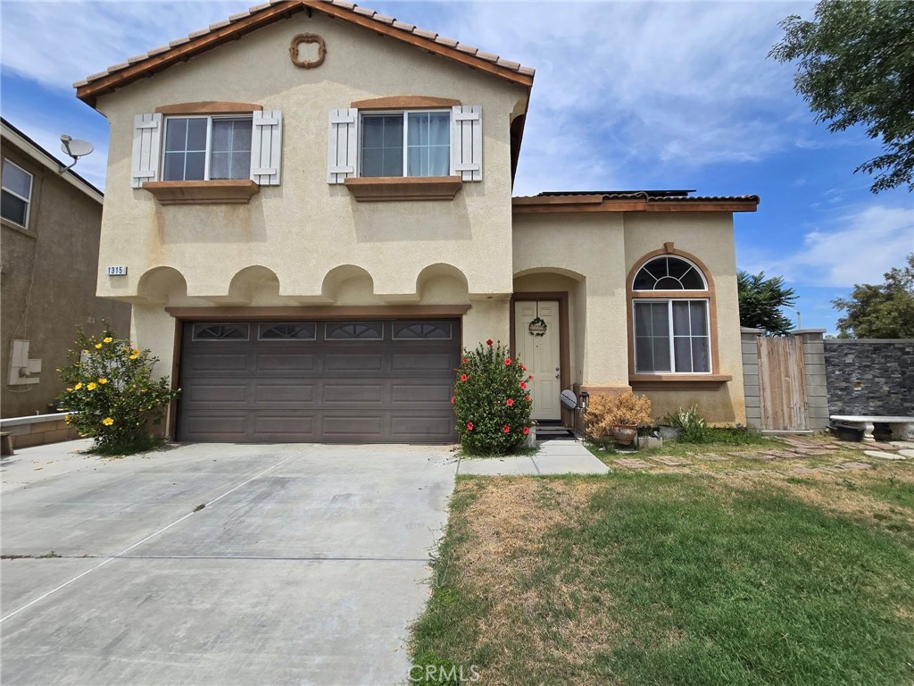 1315 Plaza Way Perris, CA 92570 - Photo 2 of 37 a front view of a house with garden