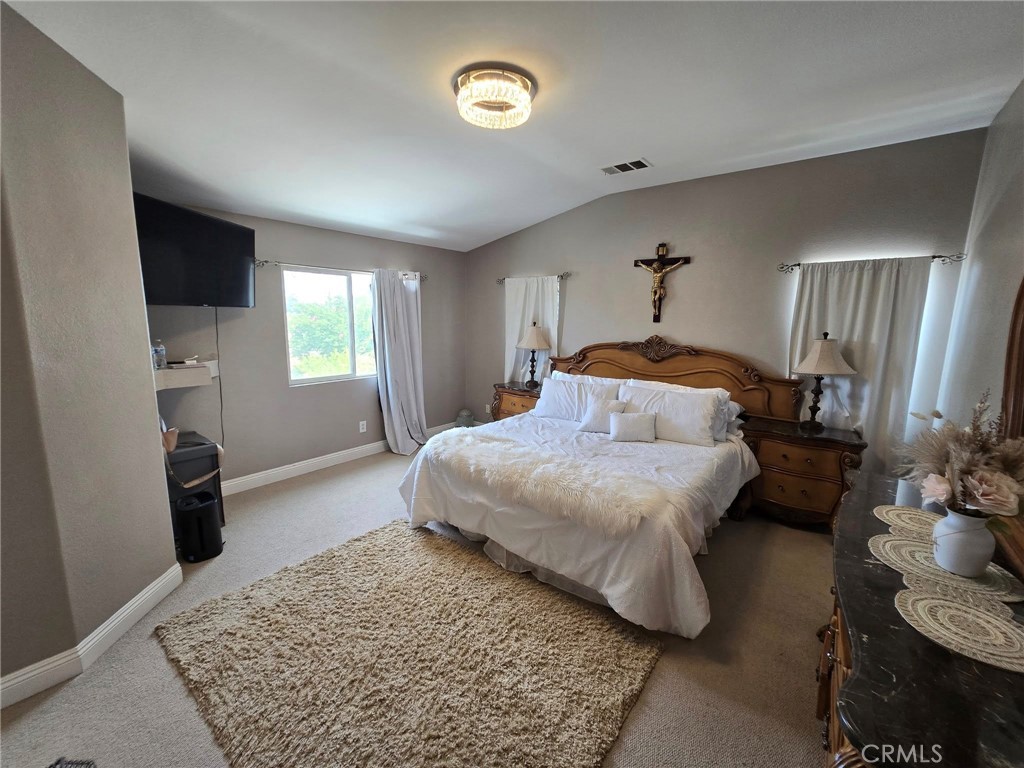 1315 Plaza Way Perris, CA 92570 - Photo 23 of 37 a bedroom with a bed and a couch