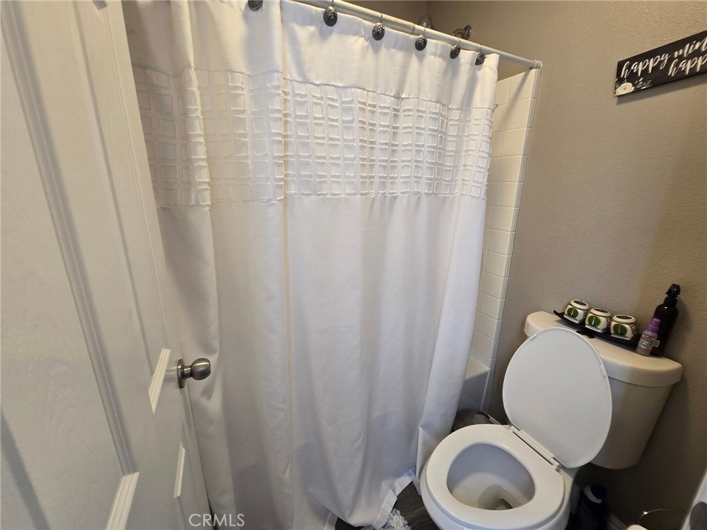 1315 Plaza Way Perris, CA 92570 - Photo 32 of 37 a bathroom with a sink and a mirror