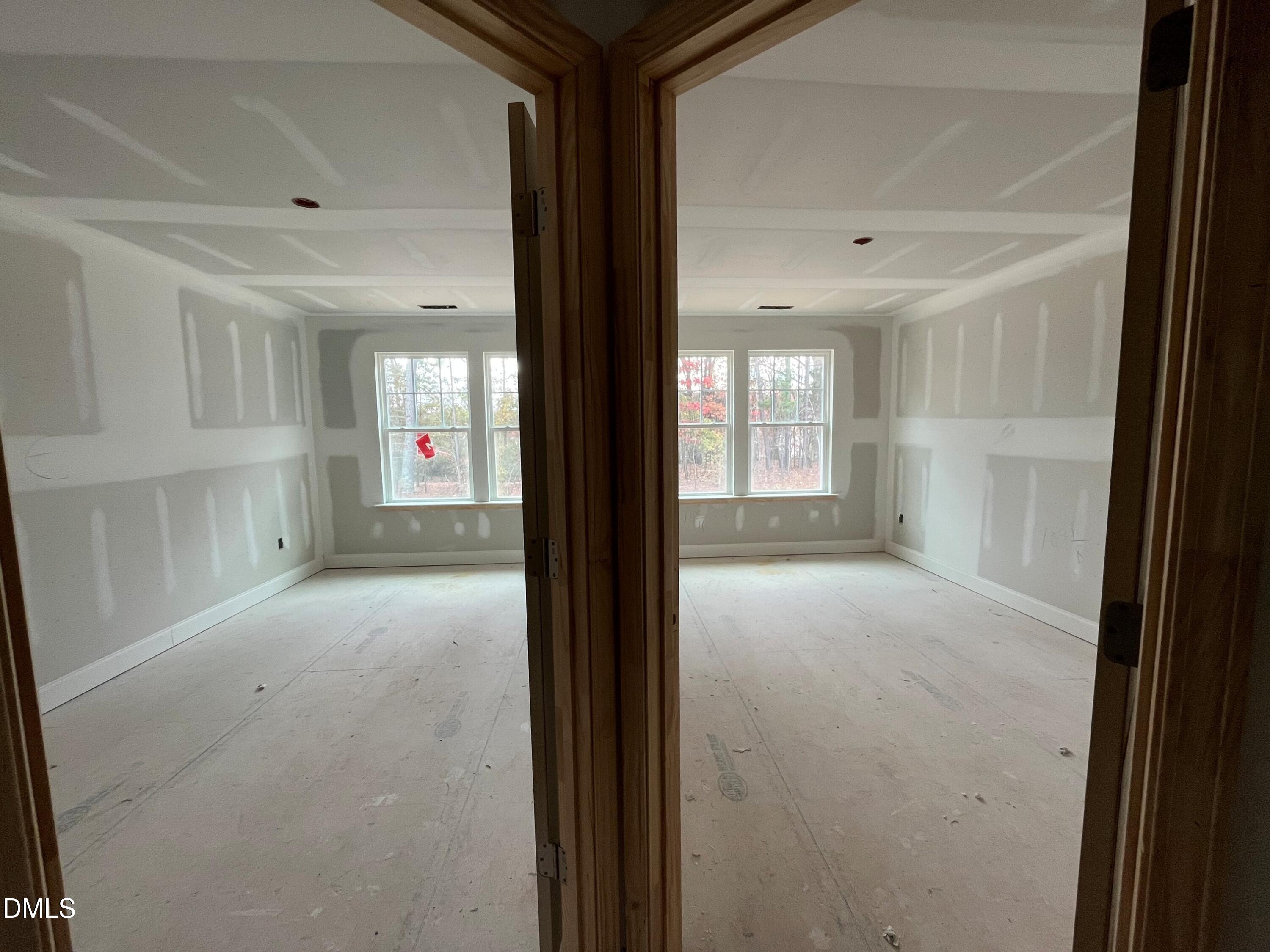 6423 Granite Quarry Drive Raleigh, NC 27610 - Photo 12 of 49 a view of a hallway with wooden floor and windows
