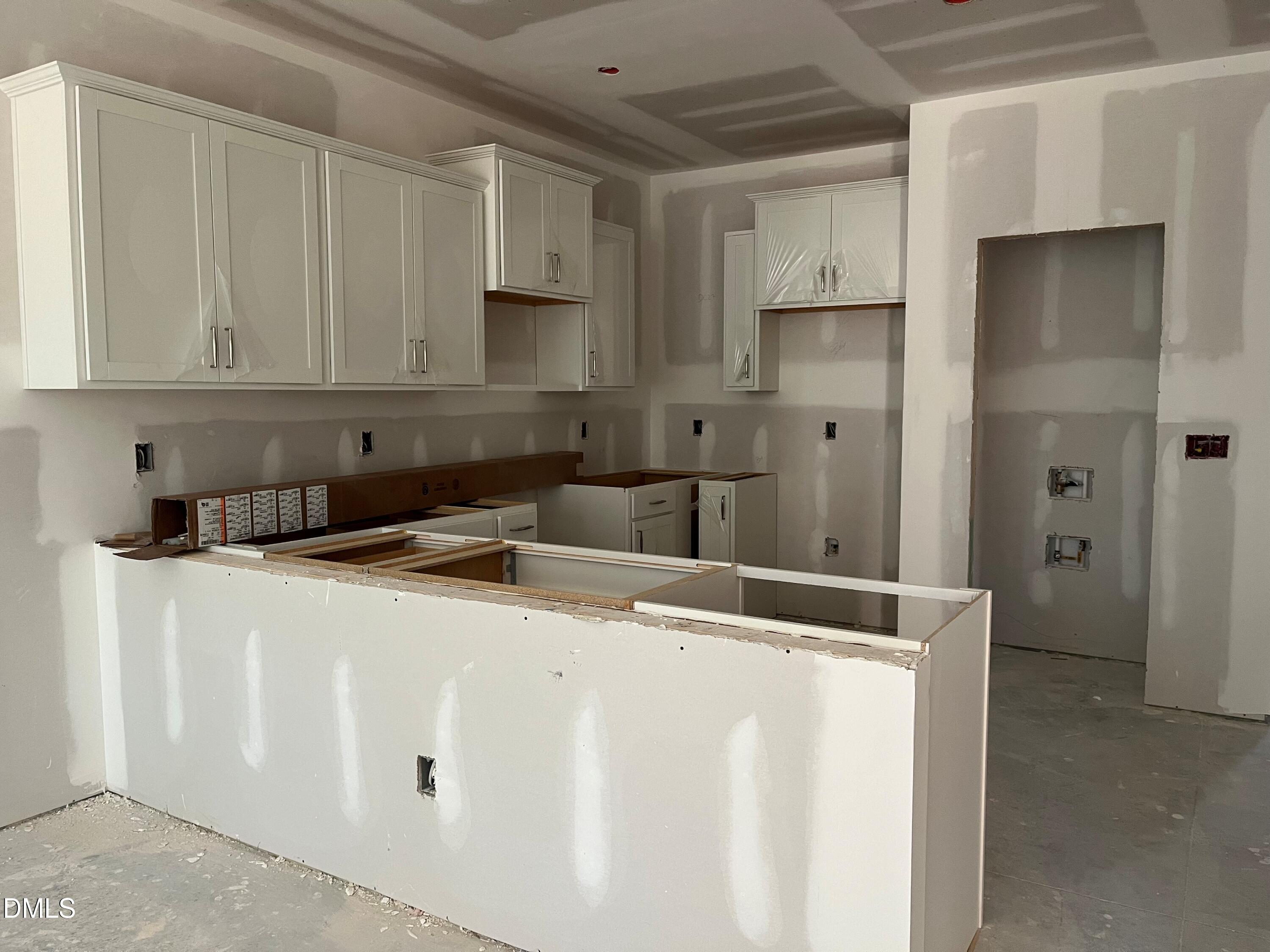 6423 Granite Quarry Drive Raleigh, NC 27610 - Photo 4 of 49 a kitchen with stainless steel appliances granite countertop a sink and a refrigerator