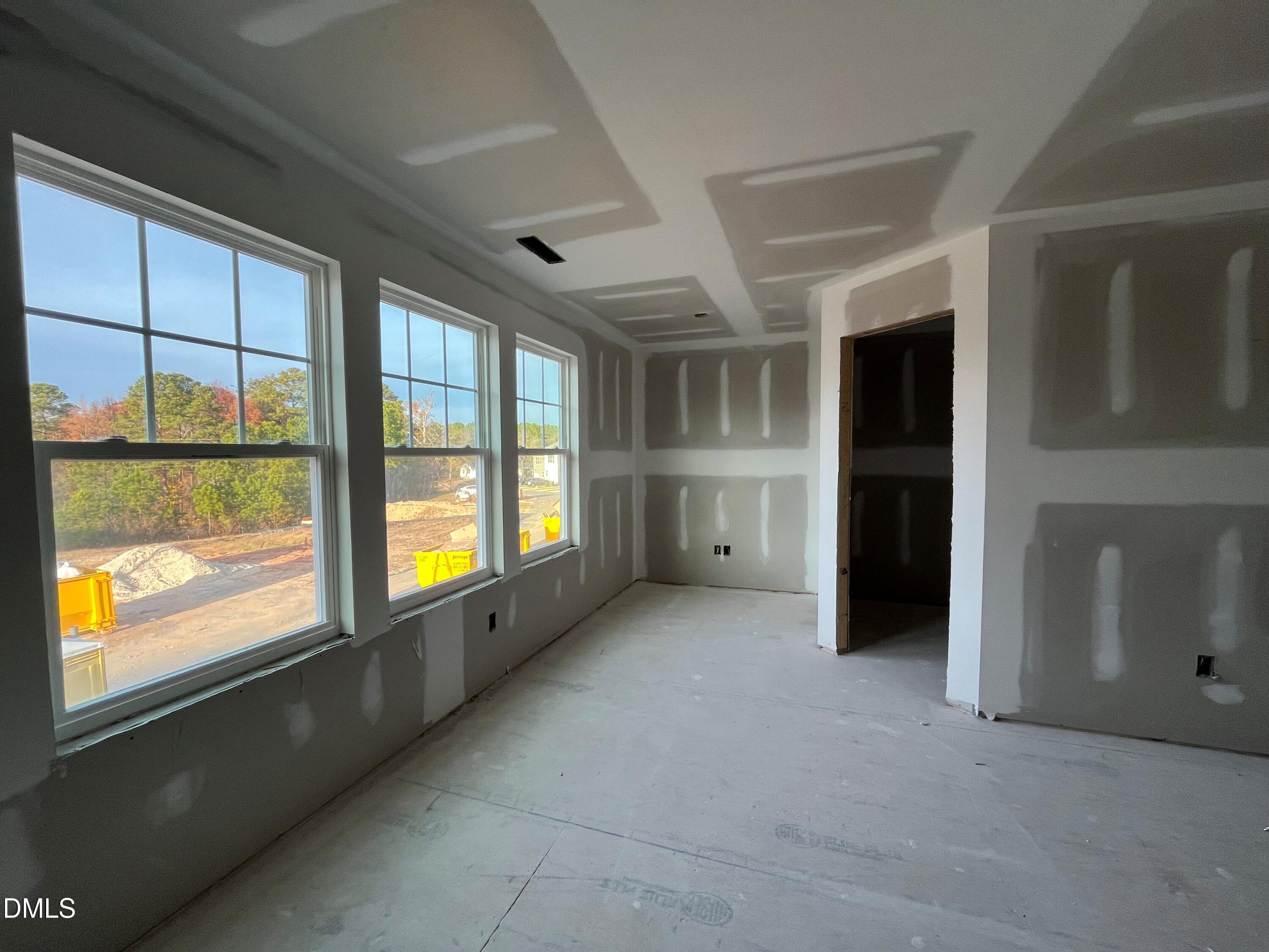 6423 Granite Quarry Drive Raleigh, NC 27610 - Photo 9 of 49 a view of an empty room with a window