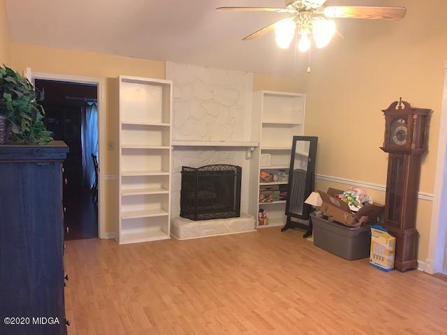 747 Gose Road Forsyth, GA 31029 - Photo 4 of 15 a bedroom with a bed and a chandelier
