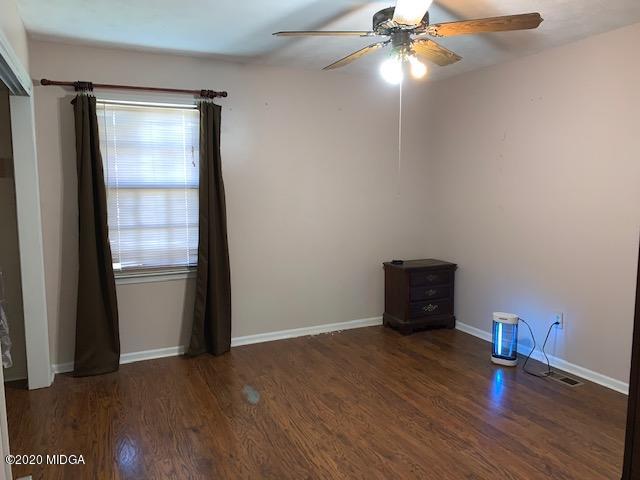 747 Gose Road Forsyth, GA 31029 - Photo 8 of 15 an empty room with wooden floor and windows