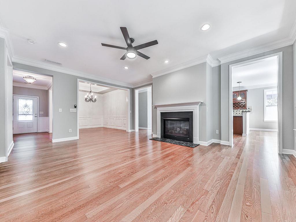 626 Laurel Crossing Canton, GA 30114 - Photo 18 of 77 wooden floor fireplace and windows in an empty room