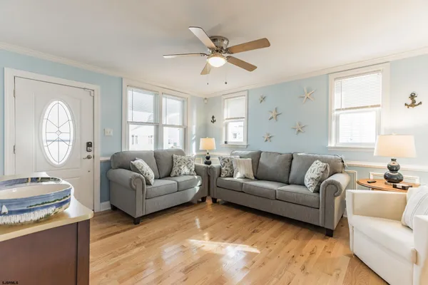 a living room with furniture and a flat screen tv