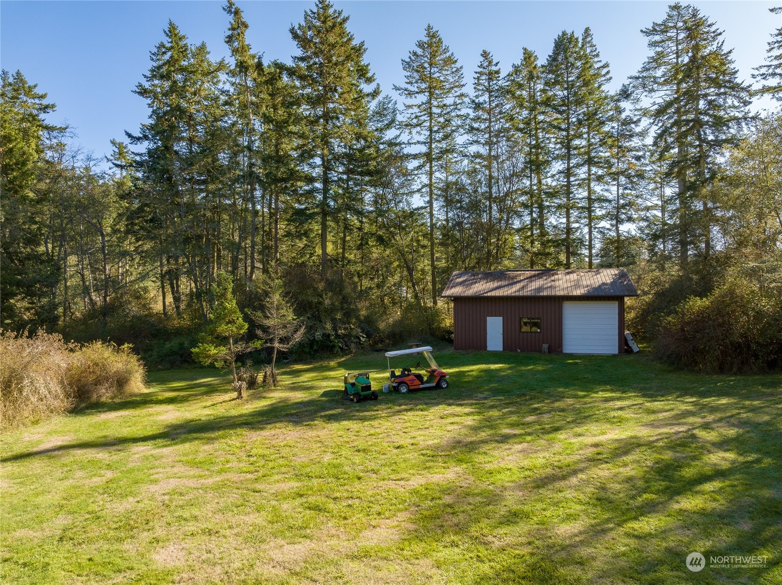 165 Sunrise Road Lopez Island, WA 98261 - Photo 5 of 12 a view of a house with a yard and a large tree