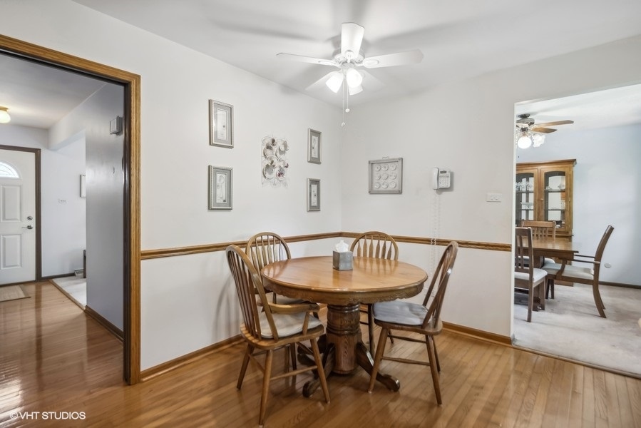 7631 Apple Tree Lane Willowbrook, IL 60527 - Photo 12 of 24 a view of a dining room with furniture and wooden floor