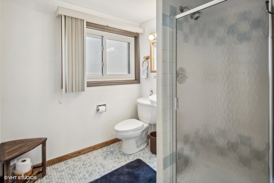 7631 Apple Tree Lane Willowbrook, IL 60527 - Photo 14 of 24 a bathroom with a toilet and a mirror