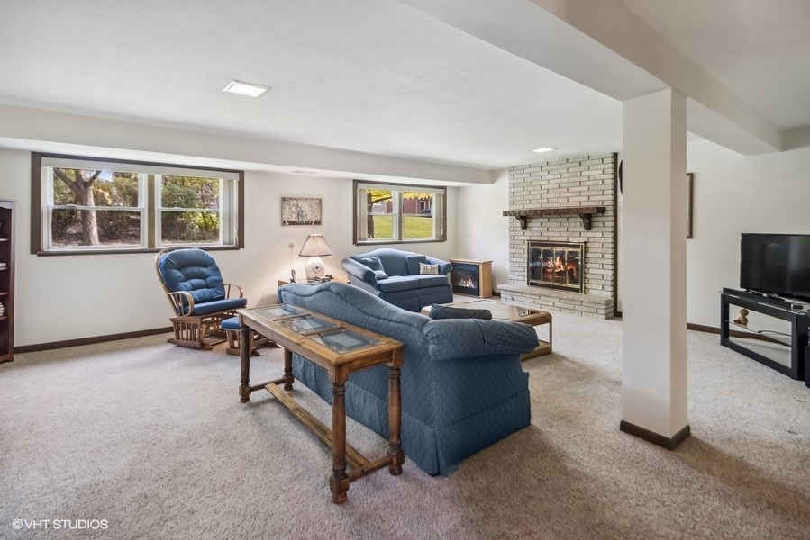 7631 Apple Tree Lane Willowbrook, IL 60527 - Photo 16 of 24 a living room with furniture and a flat screen tv