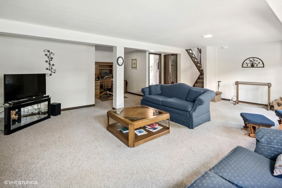 7631 Apple Tree Lane Willowbrook, IL 60527 - Photo 17 of 24 a living room with furniture and a flat screen tv