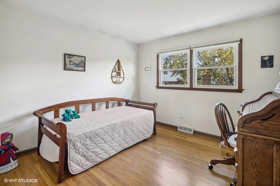 7631 Apple Tree Lane Willowbrook, IL 60527 - Photo 5 of 24 a bedroom with furniture and a window
