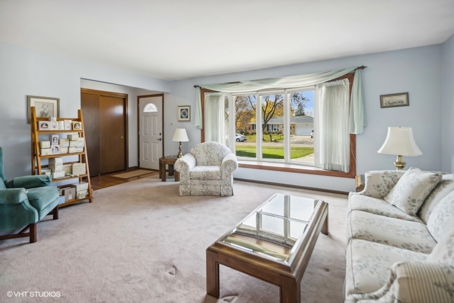 7631 Apple Tree Lane Willowbrook, IL 60527 - Photo 9 of 24 a living room with furniture and a window
