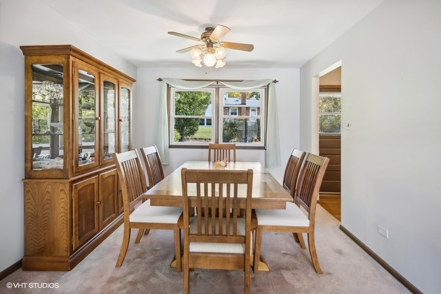 7631 Apple Tree Lane Willowbrook, IL 60527 - Photo 10 of 24 a view of a dining room with furniture a chandelier and wooden floor
