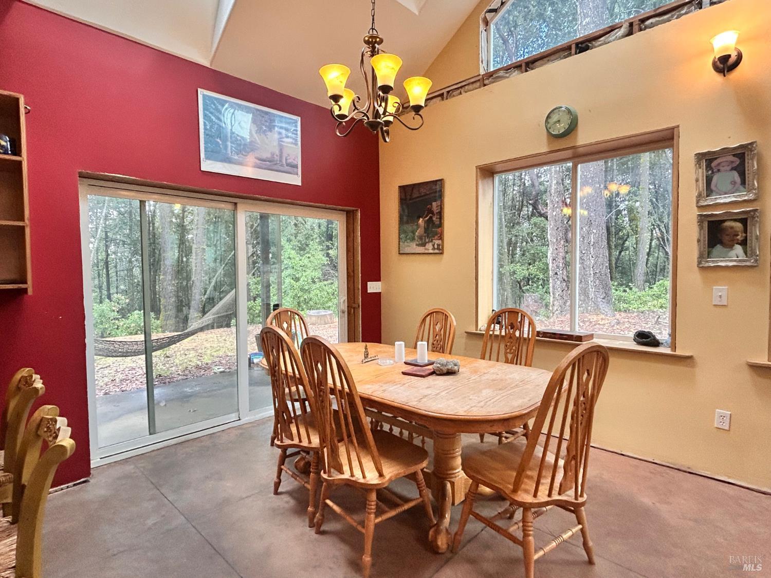 29281 Timberline Road Willits, CA 95490 - Photo 13 of 38 a dining room with furniture a large window and a chandelier