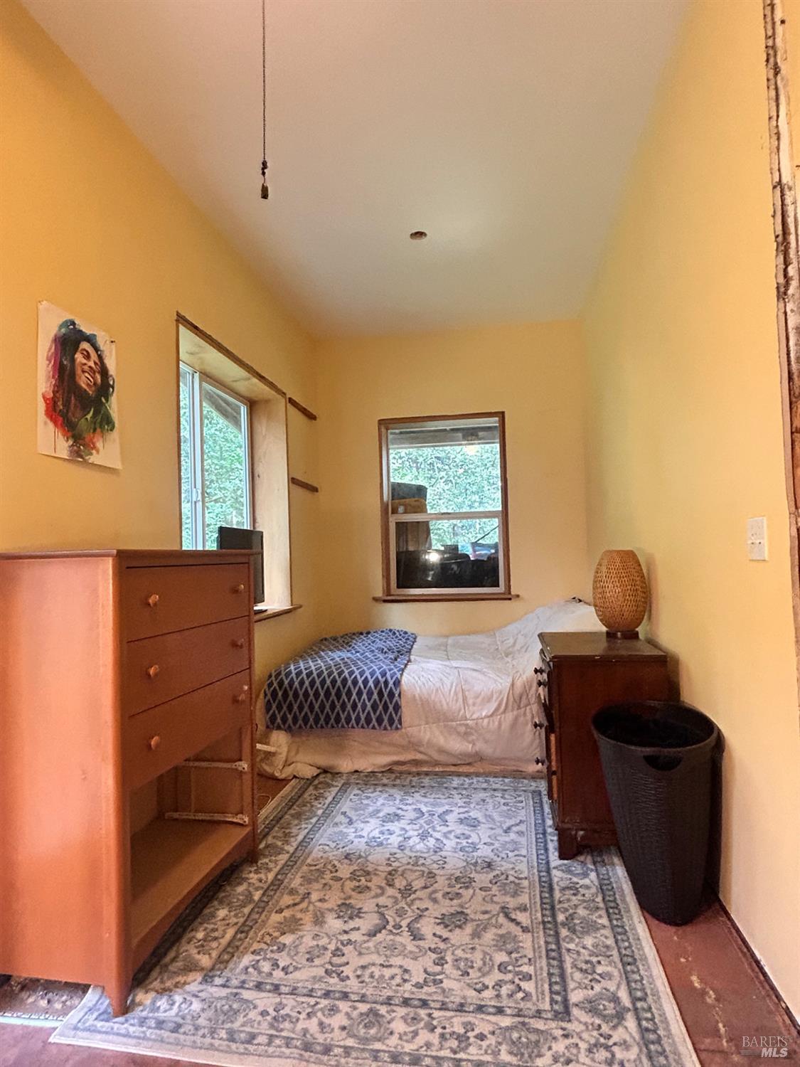 29281 Timberline Road Willits, CA 95490 - Photo 30 of 38 a bedroom with a bed and wooden floor