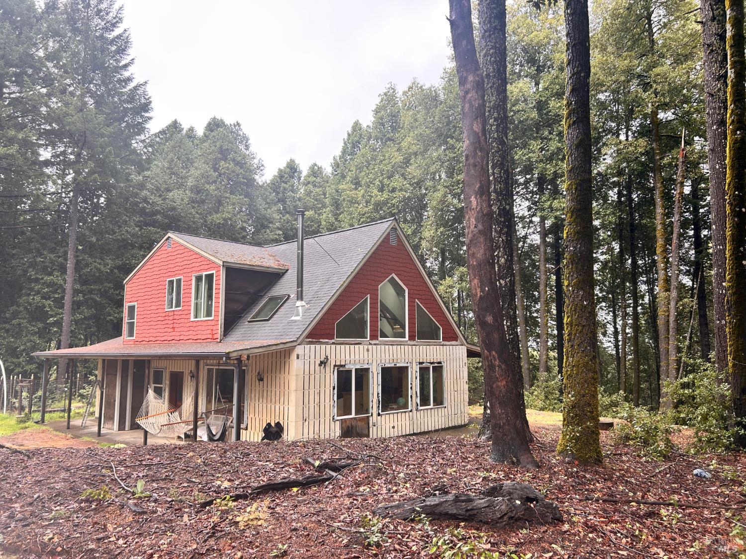 29281 Timberline Road Willits, CA 95490 - Photo 6 of 38 a view of a white house next to a yard with large trees
