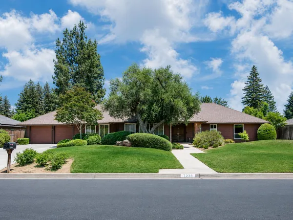 a view of house with yard and green space