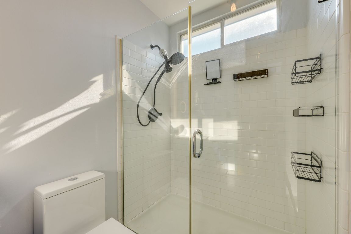 4801 South Congress Avenue, Unit S3 Austin, TX 78745 - Photo 23 of 40 a bathroom with a shower and toilet