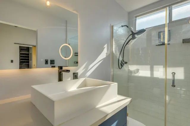 a bathroom with a tub sink and mirror