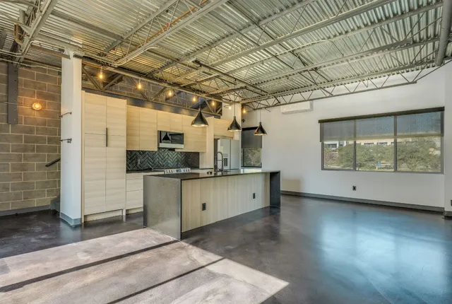 a view of a kitchen with a sink and cabinets