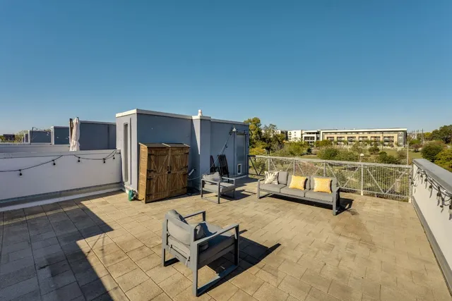 a view of a terrace with couches and sky view