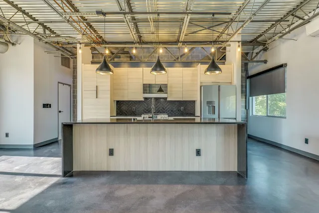 a large white kitchen with a large window